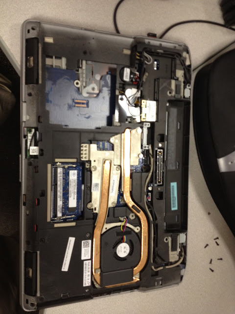 the bottom of a laptop with the bottom case removed, exposing the internals